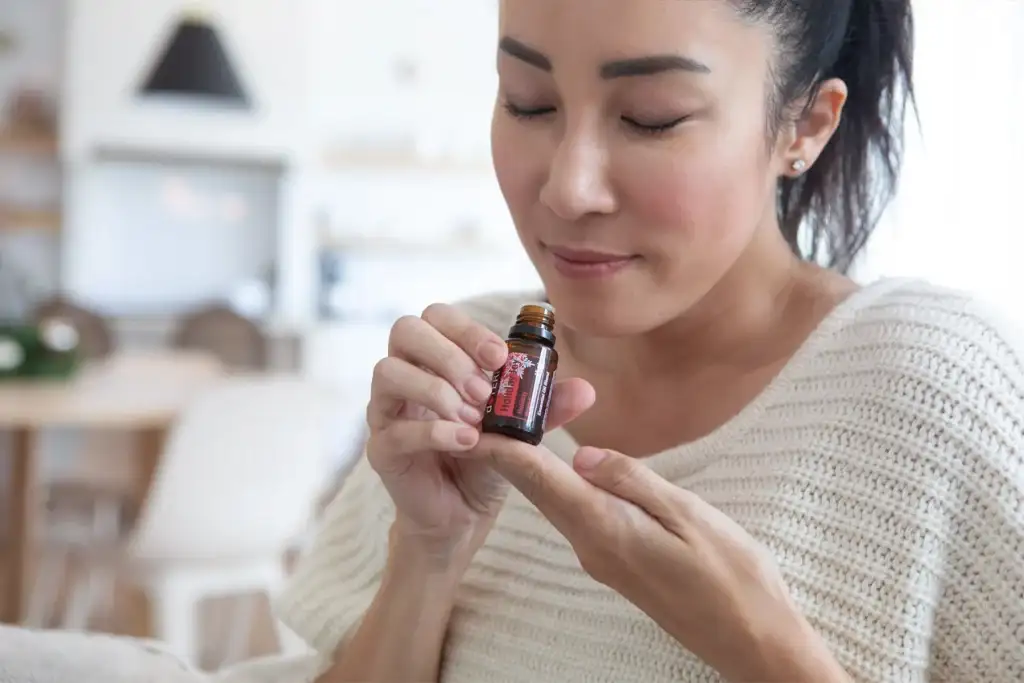 woman smelling doTERRA Holiday Joy near Christmas time