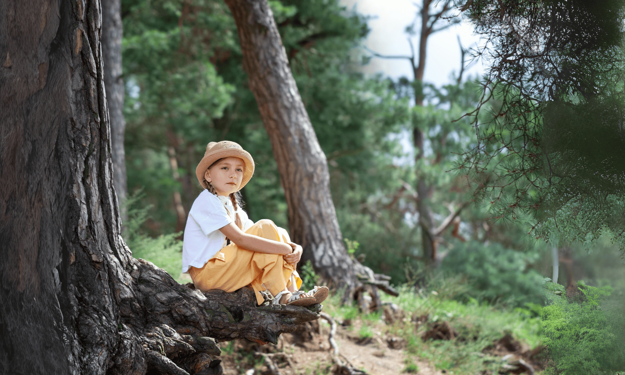 child sitting pondering in the forest edit