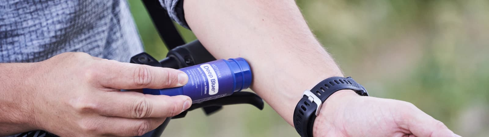 man-rubs-deep-blue-stick-on-forearm